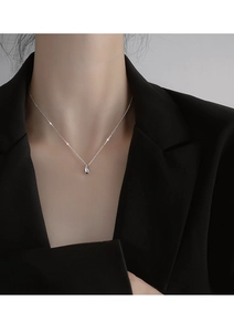 Silver teardrop necklace on model's neck with minimalist polished design detail