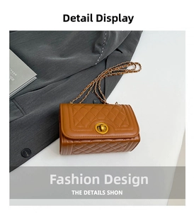 Detail of brown quilted shoulder bag with gold twist lock and leather chain strap