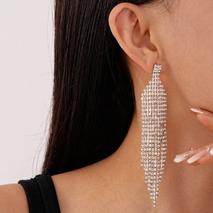 Gros plan de boucles d'oreilles à longs gland géométriques avec strass brillants sur mannequin