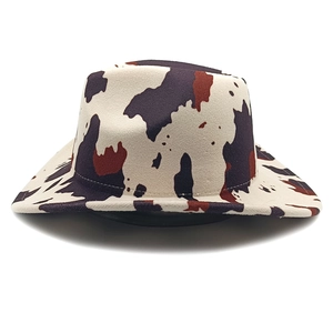 Detail of western cowboy hat featuring classic cow print pattern and wide brim texture