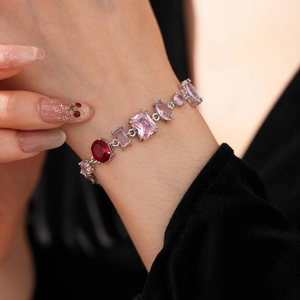 Detail of vintage silver bracelet with pink zircon gems on woman's wrist