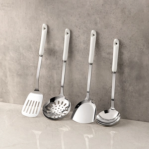 4-piece stainless steel kitchen utensil set with white ceramic handles on marble base