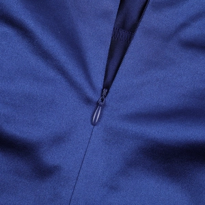 Detail shot of a seamless hidden zipper on blue knitted fabric for an elegant evening dress