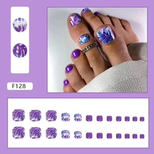 Detail view of purple floral press-on toenails featuring tropical leaf patterns