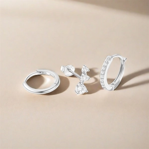 Macro detail of S925 sterling silver earring set with polished hoops and zircon studs