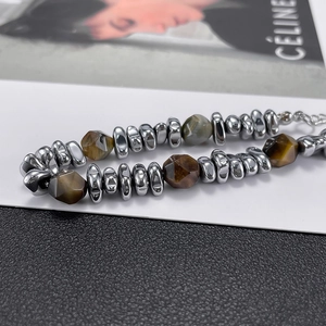 Macro shot of industrial beaded bracelet with natural tiger eye stones and lobster clasp