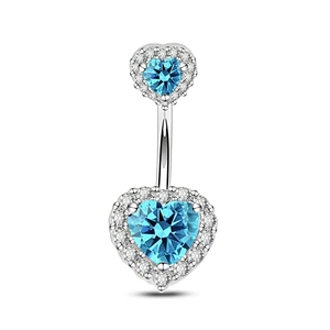 Close-up of silver navel ring with two blue heart crystals and zircon pavé detail