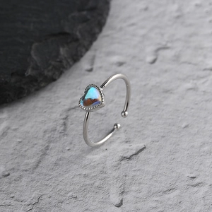 Macro shot of an adjustable heart moonstone ring with iridescent luster on a stone