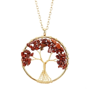 Detail of handmade gold wire-wrapped Tree of Life pendant with red jasper stones