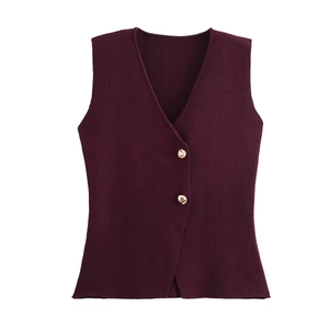 Detail of burgundy knitted vest featuring V-neckline and elegant gold metal buttons