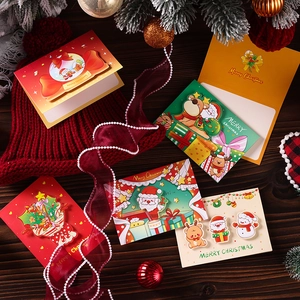 3D Christmas cards with pop-up Santa and reindeer designs on a rustic wood background