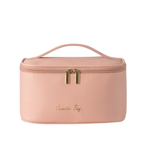 Pink cross-grain PU leather cosmetic bag with gold zippers and top handle for travel