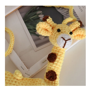Detailed close-up of handmade crochet giraffe crossbody bag with intricate knit texture