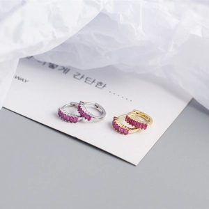 Macro shot of S925 silver hoop earrings with inlaid pink rectangular cubic zirconia stones