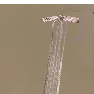 Pink polka dot ribbon hair clip with elegant white lace and pearl detail for women