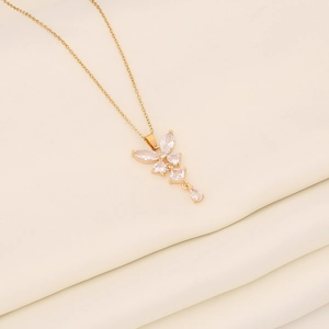 Macro detail of a golden butterfly pendant featuring sparkling marquise cut zircon stones
