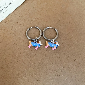 Detailed view of colorful oil-dripped dachshund earrings on textured paper background