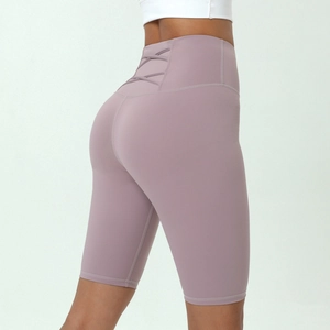 High-waist dusty rose yoga shorts featuring a crisscross back detail and slimming fit