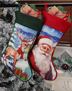 Detail of knitted Christmas stockings featuring Santa and reindeer hanging on a tree