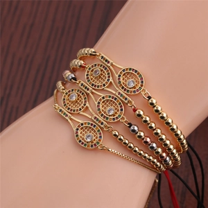 Close-up of golden adjustable bracelets with colorful zircons and tennis racket motifs