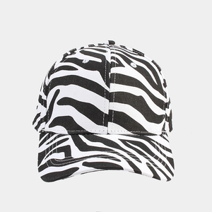 Macro shot of breathable eyelets and black and white zebra pattern on cotton baseball cap