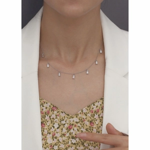 Close-up of minimalist S925 silver necklace with rectangular clear zircon pendants on a model