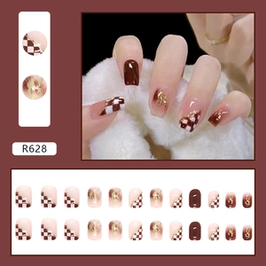 Brown checkerboard press-on nails set with gold foil and glossy chocolate finish