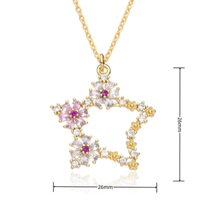 Detail shot of a 26mm gold star pendant with pink and white micro-set zircon crystals