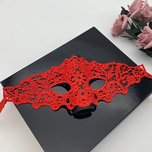 Elegant red lace masquerade mask on a black gift box with pink roses for women's costume