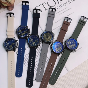Flat lay of quartz watches with colorful silicone straps on an open English book background