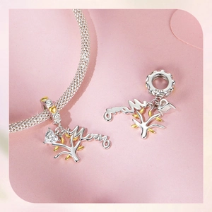 Macro detail of S925 sterling silver Tree of Life charm with Mom lettering and zircon