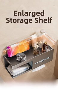 Close-up of wall-mounted dark gray aluminum tissue box with a wide storage shelf and railing