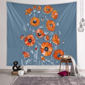 Detailed view of an orange poppy tapestry on a blue background in a cozy room setting
