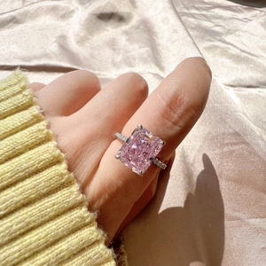 Close-up of S925 silver ring with a large rectangular pink zircon on a female finger
