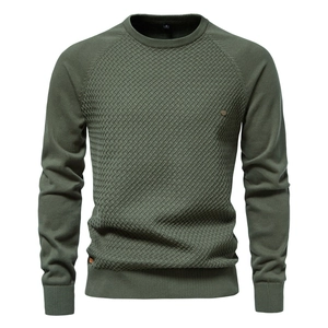 Detail of army green crewneck sweater showing raglan sleeves and diagonal knit texture