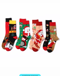 Flat lay of four pairs of cotton Christmas socks with Santa and snowman patterns