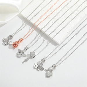Detailed close-up of heart, rose, and key pendants on S925 silver necklace chains