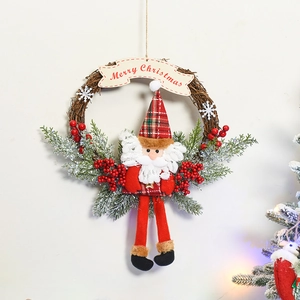 Detail of Santa Claus plush on a rustic vine wreath with pine needles and snowy berries