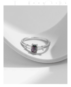 Detail of S925 silver ring featuring a rainbow zircon and emerald cut crystal