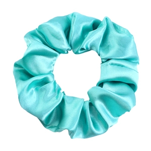 Detailed view of mint green satin scrunchie with silky texture and elegant pleats