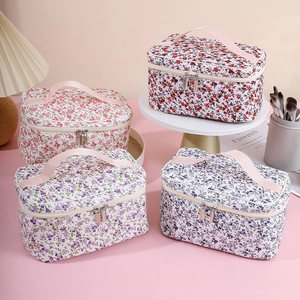 Floral large capacity makeup bags in four colors with pink handle on pink background