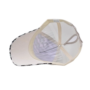 Close-up of ponytail hole and mesh fabric on printed baseball cap with care label