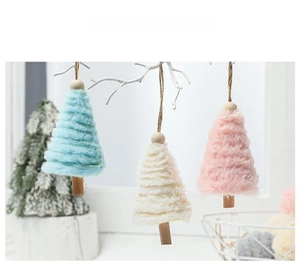Detail of plush Christmas tree ornaments with wooden beads and hanging rope in soft colors