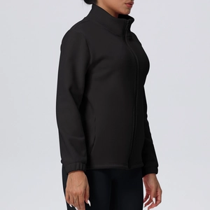 Detail of a black fleece-lined stand-collar zip-up jacket with side pockets and elastic cuffs