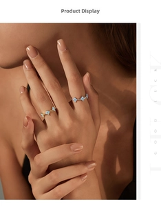 Detail of S925 silver four-leaf clover rings set in gold finish on female hand