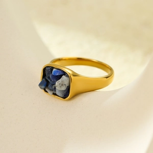 Macro detail of a gold square ring featuring inlaid blue and grey natural stone textures
