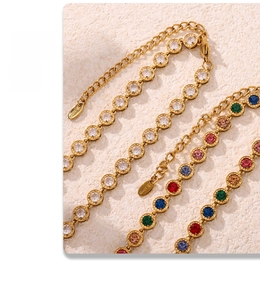Macro shot of gold stainless steel bracelets with colorful 3A zircon stones and S.Steel logo