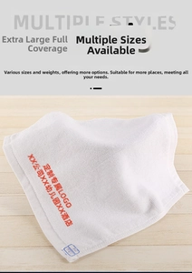 Detailed macro view of white cotton towel with fluffy loop texture and custom red embroidery