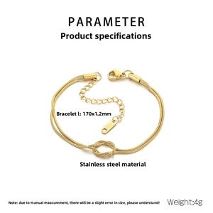 Detail of a gold double-layered snake chain bracelet with a knot design and S.STEEL tag