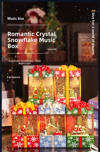 Close-up of a festive Christmas gift box music box with automatic snow and warm LED lights